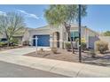 Charming single-story home with a well-maintained front yard and a two-car garage at 214 N 190Th Dr, Buckeye, AZ 85326