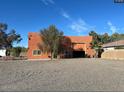 View of large stand alone garage with automatic roll up door and additional parking at 22005 N 86Th Ave, Peoria, AZ 85383