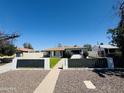 Well-maintained single-story home with desert landscaping and charming curb appeal at 2450 E Clarendon Ave, Phoenix, AZ 85016