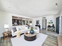 Open-concept living room with hardwood floors, neutral color palette, and recessed lighting at 2450 E Clarendon Ave, Phoenix, AZ 85016