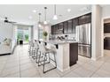 Modern kitchen featuring a large island, stainless steel appliances, and stylish pendant lighting at 25583 S 224Th Pl, Queen Creek, AZ 85142