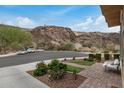 Serene front yard with desert landscaping, accent lighting, and peaceful mountain backdrop at 26868 N 104Th Ln, Peoria, AZ 85383