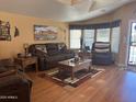 Cozy living room featuring comfortable seating, wood floors, and lots of natural light at 3301 S Goldfield Rd # 4025, Apache Junction, AZ 85119