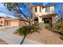 Charming two-story home showcasing manicured landscaping, a spacious driveway, and separate garage at 3603 S Weaver E Cir, Gilbert, AZ 85297