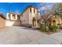 Stunning two-story home showcasing a large driveway, neutral stucco, and unique architectural details at 3603 S Weaver E Cir, Gilbert, AZ 85297