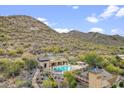 Community pool area surrounded by desert landscape with mountain views at 36600 N Cave Creek Rd # D11, Cave Creek, AZ 85331