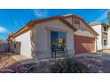 Inviting single-story home with a well-kept yard and an attached two-car garage at 38226 N Kyle St, San Tan Valley, AZ 85140