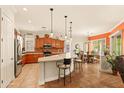 Open kitchen featuring a large center island, stainless steel appliances, and adjacent dining area at 4138 E Indigo St, Gilbert, AZ 85298