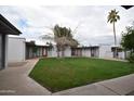 Inviting outdoor common space with mature tree and lush lawn at the Arcadia Courtyards at 4206 N 38Th St # 3, Phoenix, AZ 85018