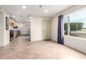 Bright entryway featuring tile flooring, a large window, and convenient access to the kitchen at 4701 E Voltaire Ave, Phoenix, AZ 85032