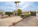 Inviting single-Gathering home featuring a long driveway and a meticulously manicured front yard at 4701 E Voltaire Ave, Phoenix, AZ 85032