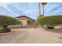 Lovely single-story home with beautiful landscaping showcasing mature trees and manicured shrubs at 4701 E Voltaire Ave, Phoenix, AZ 85032