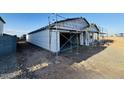 Home construction with visible garage framework, siding installation, and newly constructed roof at 47248 W Cansados Rd, Maricopa, AZ 85139