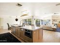 Open-concept kitchen featuring a large island with seating, modern appliances, and plenty of natural light at 5137 E Flower St, Phoenix, AZ 85018