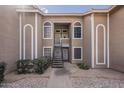 Charming two-story condo with beautiful arched windows, stone accents, and tidy landscaping at 5230 E Brown Rd # 117, Mesa, AZ 85205