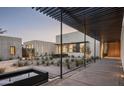 Architectural home exterior features a modern design with a covered walkway and drought-tolerant landscaping at 5287 N Invergordon Rd, Paradise Valley, AZ 85253