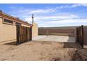 Spacious backyard with fencing, gravel, and concrete, offering plenty of space at 61 S 111Th Pl, Mesa, AZ 85208