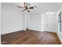 Bright living room with hardwood floors, a ceiling fan, and neutral paint at 61 S 111Th Pl, Mesa, AZ 85208