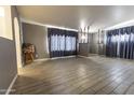 Living room area showcasing light-colored flooring, transom windows, and gray walls at 913 N Trekell Rd, Casa Grande, AZ 85122