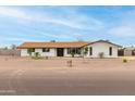 Charming single-story home featuring a white brick exterior, black trim, and a well-manicured front yard at 9305 W Calle Lejos --, Peoria, AZ 85383