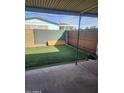 Cozy covered patio with artificial grass at 934 S Evangeline Ave, Mesa, AZ 85208