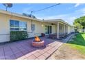 Private backyard with a cozy firepit, covered patio, and well-maintained landscaping at 10226 W Snead S Cir, Sun City, AZ 85351