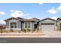 Charming single-story home featuring a two-car garage, desert landscaping, and a neutral color palette at 10322 E Topaz Ave, Mesa, AZ 85212