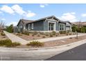 Single Gathering home with well-kept landscaping, sidewalk and a gray stucco exterior at 10322 E Topaz Ave, Mesa, AZ 85212