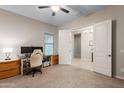 Bright home office featuring neutral carpet, ample workspace, and double doors leading to the foyer at 10322 E Topaz Ave, Mesa, AZ 85212