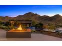 Backyard view featuring a fire pit and water feature with desert mountain views at 10324 E Calle De Las Brisas --, Scottsdale, AZ 85255