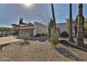 A well-maintained home with desert landscaping and a two-car garage on a sunny day at 10421 E Silvertree Dr, Sun Lakes, AZ 85248