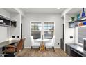 Cozy breakfast nook with white chairs and a view through the windows at 10942 E Sonrisa Ave, Mesa, AZ 85212