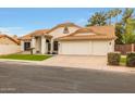 Charming single-story home with tile roof, three car garage, and green lawn at 1114 S Presidio Ave, Gilbert, AZ 85233