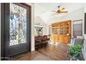 Cozy dining area featuring a bar, beautiful wood floors and an ornate iron door at 11152 E White Feather Ln, Scottsdale, AZ 85262