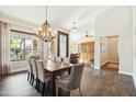 Bright dining room with wood floors, a chandelier, and large windows offering scenic views at 11152 E White Feather Ln, Scottsdale, AZ 85262