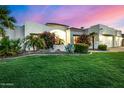 Beautiful single-story home with lush green grass and desert landscaping at 11343 E Appaloosa Pl, Scottsdale, AZ 85259