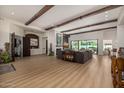 Open living room with wood flooring, ceiling beams and modern decor at 11343 E Appaloosa Pl, Scottsdale, AZ 85259