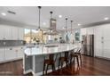 Modern kitchen featuring an oversized island, stainless steel appliances, and natural light at 12918 W Caraveo Pl, Peoria, AZ 85383