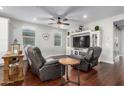 Cozy living room with comfortable seating, a ceiling fan, and a large entertainment center at 12918 W Caraveo Pl, Peoria, AZ 85383