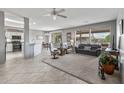 Bright living room featuring tile floors, an open layout, and ample natural light at 15116 W Carbine Way, Sun City West, AZ 85375