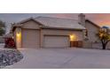 View of a three-car garage and a driveway leading to the house at sunset at 15646 E Sunflower Dr, Fountain Hills, AZ 85268