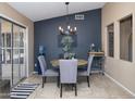 A quaint dining area featuring a modern chandelier, table and chairs adjacent to a glass sliding door at 16409 S 46Th St, Phoenix, AZ 85048