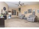 Spacious living room with vaulted ceilings, ceiling fan, fireplace and two recliners at 16409 S 46Th St, Phoenix, AZ 85048