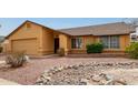 Charming single-story home featuring a neutral-colored exterior, attached garage, and desert landscaping at 1647 E Christina St, Casa Grande, AZ 85122