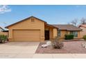 Charming single-story home featuring a neutral-colored exterior, attached garage, and desert landscaping at 1647 E Christina St, Casa Grande, AZ 85122