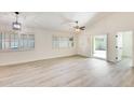 Light-filled bedroom with wood flooring, plantation shutters, and sliding glass door access at 1713 E Morelos St, Chandler, AZ 85225