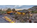 Inviting exterior showcasing desert landscaping, outdoor lighting, and sunset views of the hillside home at 1844 E Cinnabar Ave, Phoenix, AZ 85020