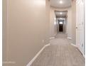 Open hallway featuring wood-look tile flooring, neutral paint, and recessed lighting, providing a seamless transition at 19975 W Glenrosa Ave, Litchfield Park, AZ 85340