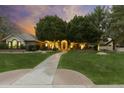 Charming single-story home with lush green lawn, mature trees, and inviting walkway leading to the front door at 2170 E Caroline Ln, Tempe, AZ 85284