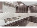 Gourmet kitchen with marble backsplash, stainless steel hood, and plenty of cabinet space at 22891 E Via Del Sol --, Queen Creek, AZ 85142